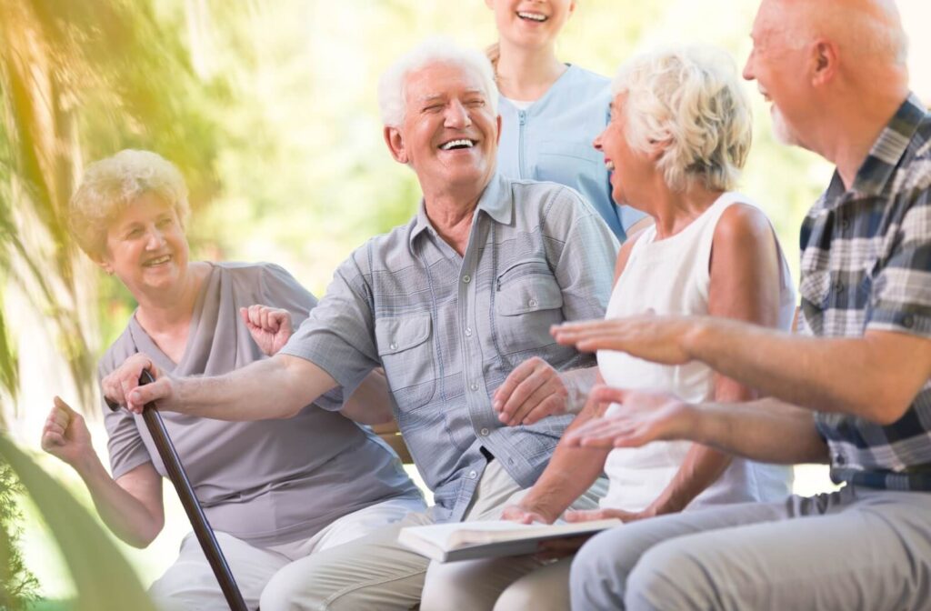 a group of seniors in memory care laugh and chat